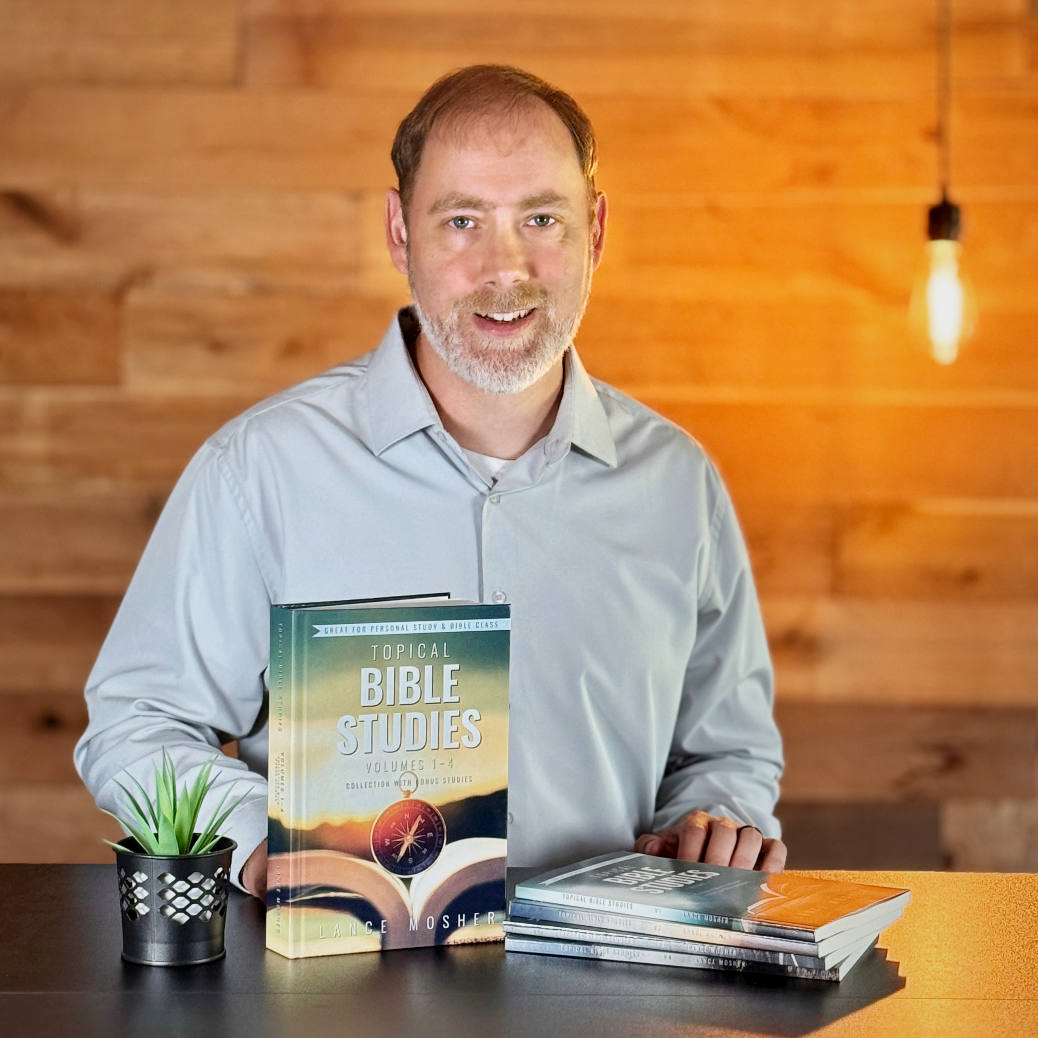 Lance Mosher with his Topical Bible Studies collection and original volumes